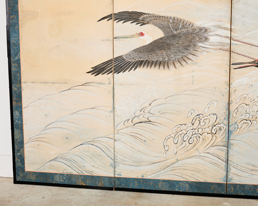 Pair of Japanese Meiji Six Panel Screen Cranes Above Cresting Waves